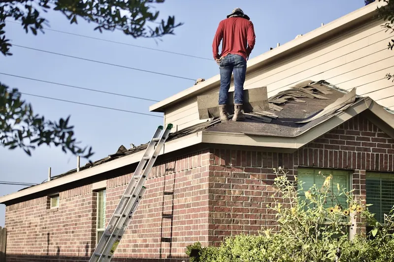 Professional roofer working on a residential roof in Bowlusville